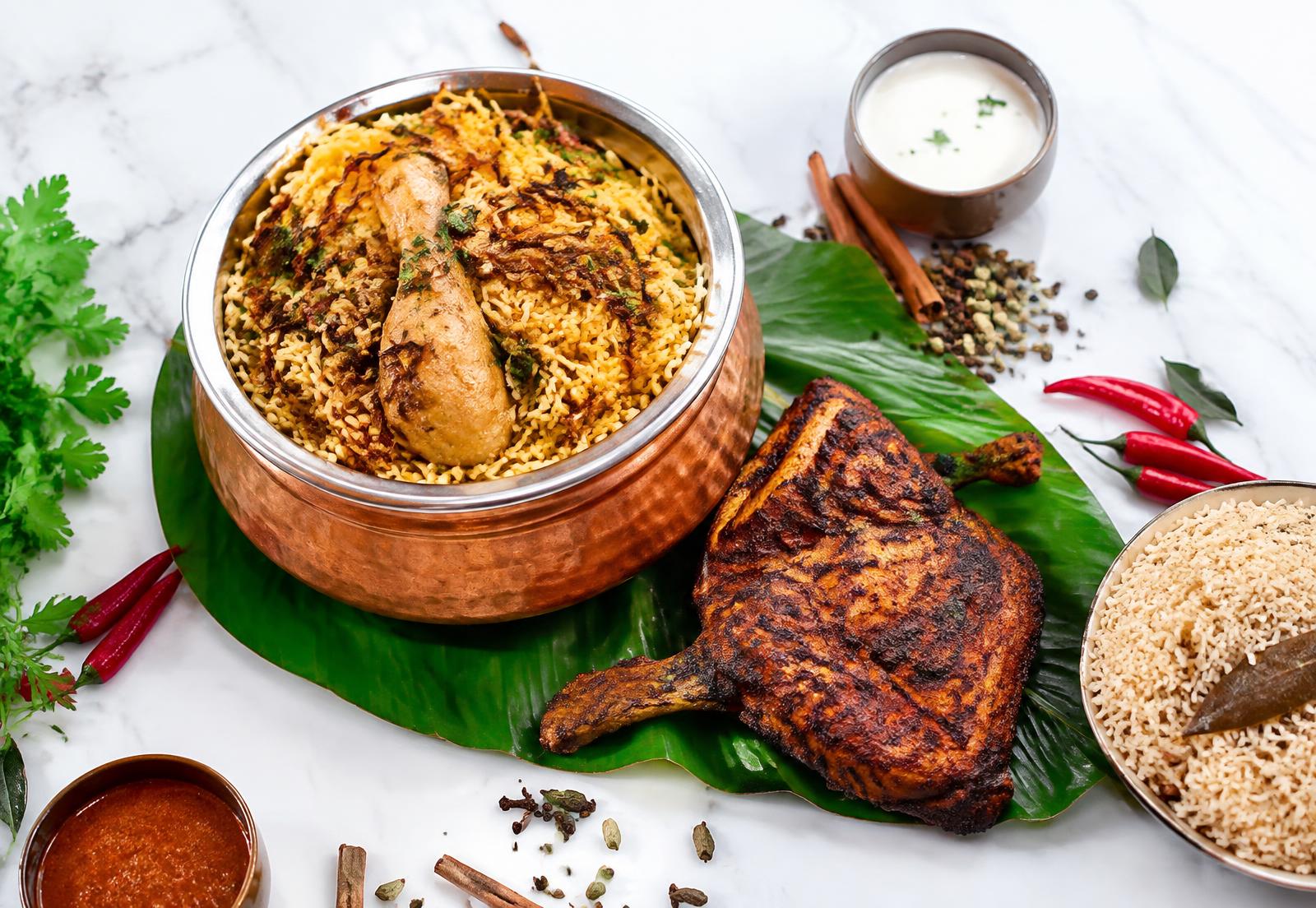 Biriyani in a copper pot with grilled alfaham chicken